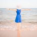 Young woman in blue dress at the beach